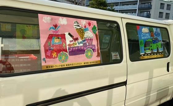 東京都トラック協会絵画作品コンテスト受賞者の絵が貼ってあるトラックの写真